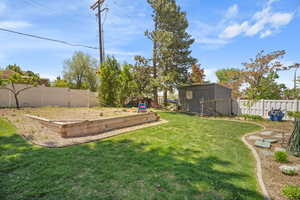 View of yard with a vegetable garden and an outdoor structure