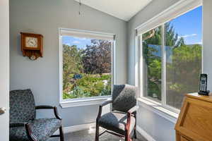 Upstairs Primary Suite Sitting room featuring carpet flooring, baseboards, and lofted ceiling