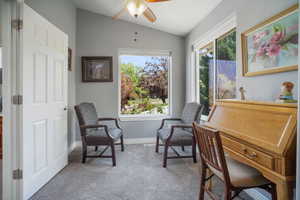 Upstairs Primary Suite Sitting room with vaulted ceiling, carpet flooring, a ceiling fan, and baseboards