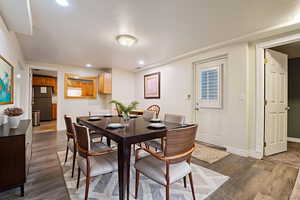 VIRTUALLY STAGED DINING  SPACE  dark wood-style flooring and recessed lighting