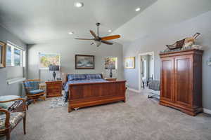Upstairs Primary Suite featuring light colored carpet, vaulted ceiling, a textured ceiling, baseboards, and recessed lighting