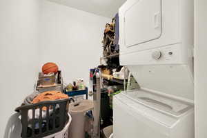Laundry area featuring stacked washer / drying machine