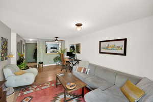 Living area with wood finished floors and a ceiling fan