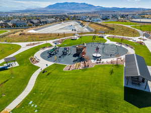 Aerial view of residential area featuring a community park and mountains