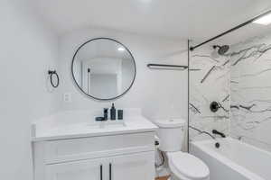 Bathroom with vanity, washtub / shower combination, and toilet