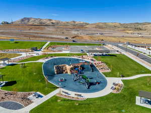 Drone / aerial view of a community park and a mountainous background
