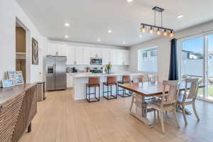 Dining space featuring healthy amount of natural light, light wood-type flooring, and recessed lighting
