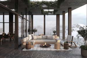 Living area featuring a mountain view, expansive windows, hardwood / wood-style floors, and plenty of natural light