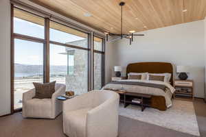Carpeted bedroom with a chandelier, a mountain view, wood ceiling, and recessed lighting