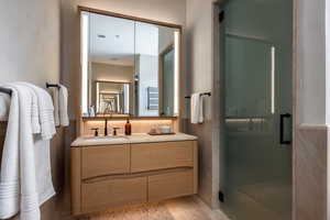 Bathroom with a stall shower and vanity