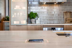 Kitchen view of wall chimney exhaust hood and black electric stovetop