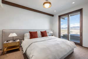 Carpeted bedroom with access to exterior, recessed lighting, beam ceiling, and a mountain view