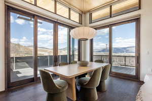 Dining area featuring a mountain view and dark wood-type flooring