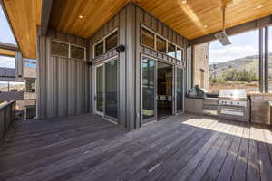 Wooden terrace with exterior kitchen, area for grilling, and a mountain view