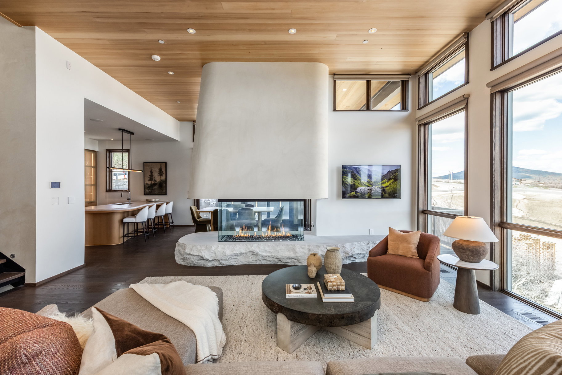 Living room featuring wooden ceiling, wood finished floors, recessed lighting, and a multi sided fireplace