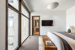Bedroom with ensuite bath and recessed lighting