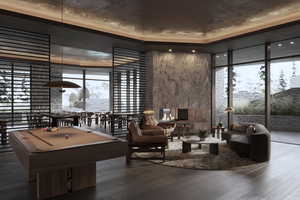 Game room with floor to ceiling windows, hardwood / wood-style floors, plenty of natural light, and billiards