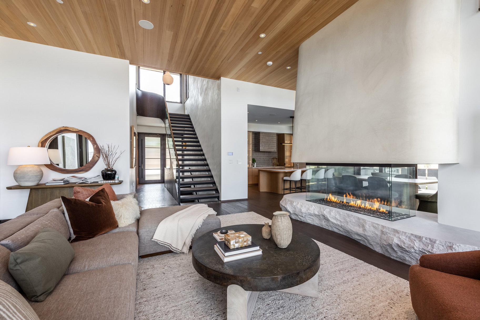 Living room featuring wooden ceiling, recessed lighting, stairway, wood finished floors, and a high ceiling
