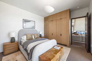 Bedroom with a closet and light colored carpet