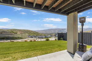 View of yard with a mountain view and a patio area