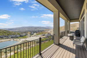 Balcony featuring view of pool area, a mountain view, and area for grilling
