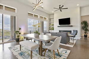 Dining room with healthy amount of natural light, a glass covered fireplace, built in features, recessed lighting, and dark wood finished floors