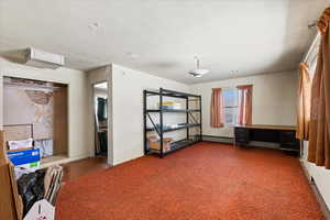 Family room with baseboard radiator and baseboards