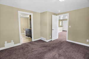 Empty room with light carpet and baseboards