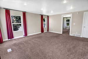 Carpeted empty room with healthy amount of natural light, baseboards, and recessed lighting