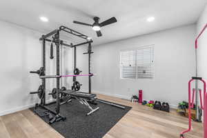 Exercise room with a ceiling fan, hardwood / wood-style flooring, baseboards, and recessed lighting