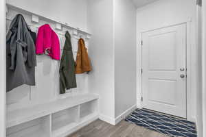Mudroom with wood finished floors and baseboards