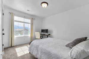 Carpeted bedroom with baseboards