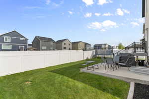 View of yard with a trampoline, a patio, a residential view, and stairway
