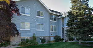 View of property exterior featuring a lawn
