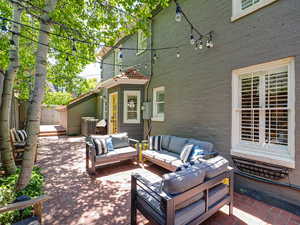 View of patio featuring an outdoor living space, central AC, and fence