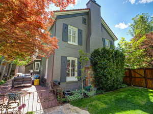 Back of property with an outdoor hangout area, a patio area, stucco siding, and a chimney