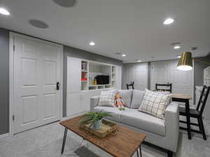 Living room featuring light carpet, recessed lighting, and baseboards