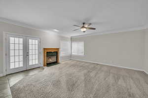 Family room right off of the kitchen with fireplace and french doors to the patio.