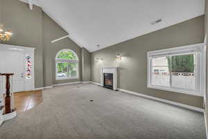 Living room/Dining room combo, featuring high vaulted ceilings and fireplace
