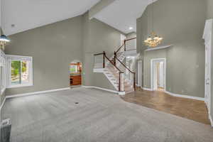 Living room/Dining room combo with high vaulted ceiling and tile foyer.