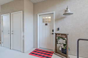 Property entrance with stucco siding