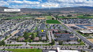 Aerial view of residential area with a water and mountain view and property boundaries highlighted