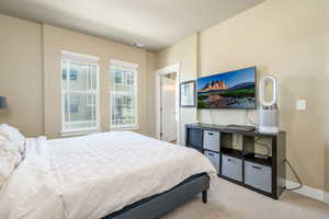 Bedroom featuring carpet floors and baseboards