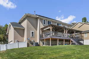 Rear view of property featuring stucco siding, a deck, stairway, and cooling unit