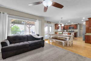Living room featuring recessed lighting, light wood finished floors, and ceiling fan