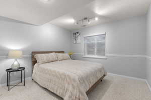 Bedroom with carpet floors and baseboards