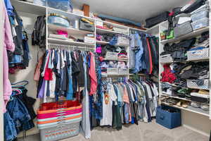 Walk in closet featuring carpet