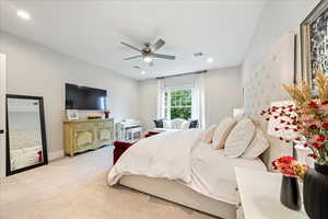 Bedroom with light carpet, recessed lighting, ceiling fan, and baseboards