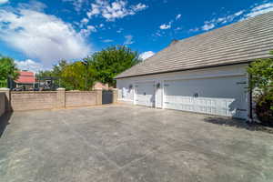 Garage featuring a gate and fence