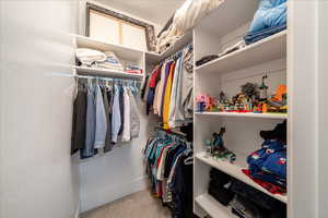 Walk in closet featuring carpet